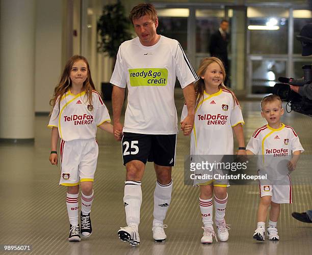 Bernd Schneider of Schnix All Stars walks to the pitch with his children before the Bernd Schneider farewell match between Bayer 04 Leverkusen and...