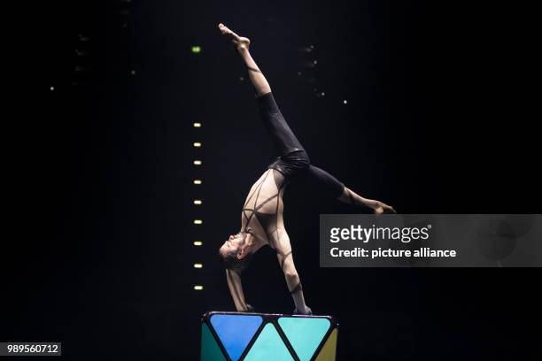 Ukranian handstand equilibrist Sergey Timofeev performing on a cube at the "Feuerwerk der Turnkunst" event at the EWE-Arena in Oldenburg, Germany,...