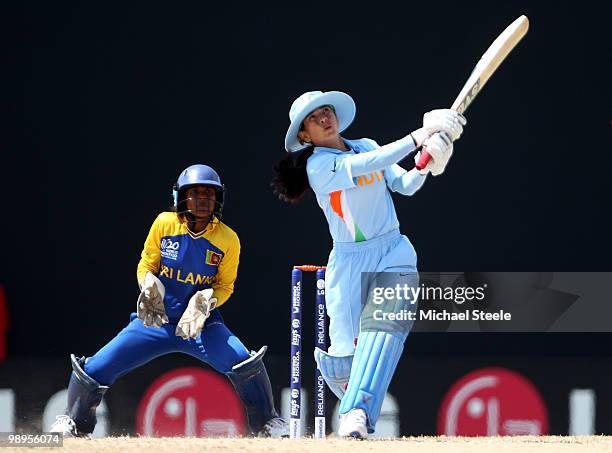 Sulakshana Naik of India hits out as wicketkeeper Dilani Manodara looks on during the ICC T20 Women's World Cup Group B match between India and Sri...