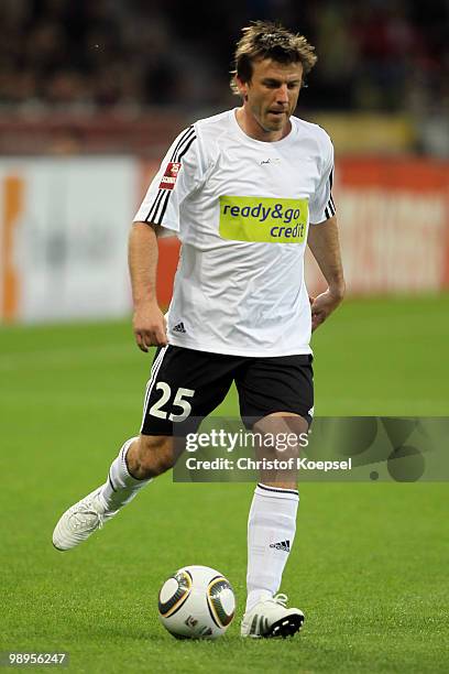 Bernd Schneider of Schnix All Stars runs with the ball during the Bernd Schneider farewell match between Bayer Leverkusen and Schnix All Stars at the...