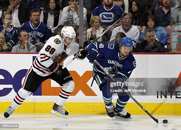 Patrick Kane of the Chicago Blackhawks back checks as Michael Grabner of the Vancouver Canucks skates up ice with the puck in Game Four of the...