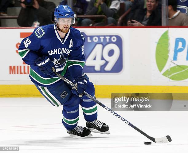 Henrik Sedin of the Vancouver Canucks skates up ice with the puck in Game Four of the Western Conference Semifinals against the Chicago Blackhawks...