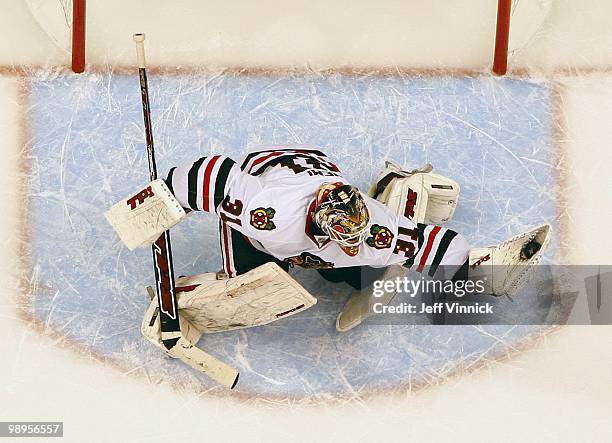 Antti Niemi of the Chicago Blackhawks makes a glove save in Game Four of the Western Conference Semifinals against the Vancouver Canucks during the...