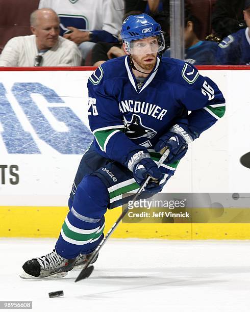 Mikael Samuelsson of the Vancouver Canucks skates up ice with the puck in Game Four of the Western Conference Semifinals against the Chicago...