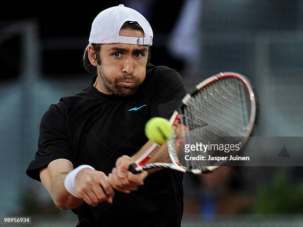 Benjamin Becker of Germany plays a backhand to Carlos Moya of Spain in their first round match during the Mutua Madrilena Madrid Open tennis...