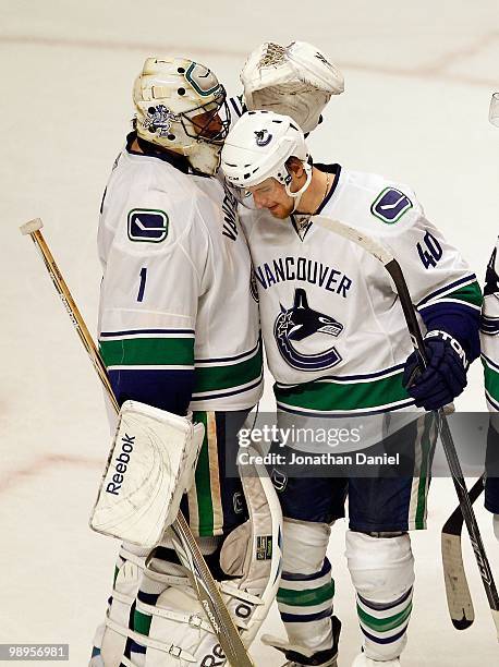 Roberto Luongo of the Vancouver Canucks is congratulated by Michael Grabner after a win over the Chicago Blackhawks in Game Five of the Western...