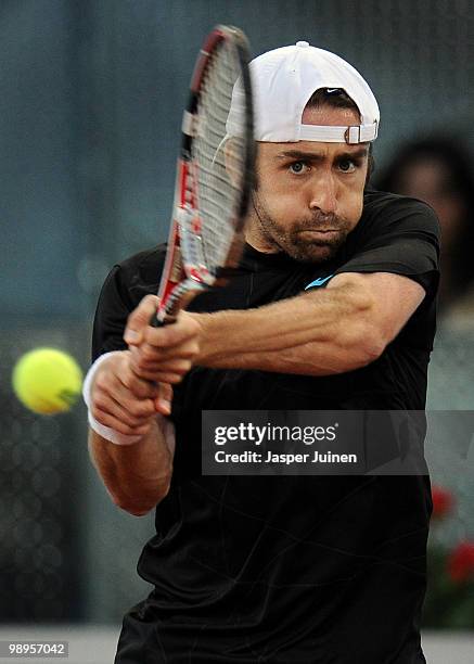 Benjamin Becker of Germany plays a backhand to Carlos Moya of Spain in their first round match during the Mutua Madrilena Madrid Open tennis...