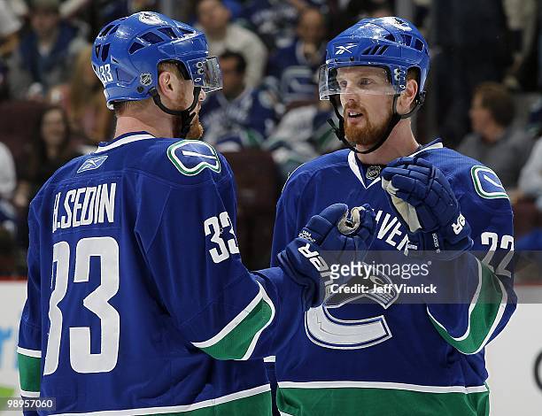 Daniel Sedin and Henrik Sedin of the Vancouver Canucks discuss strategy in Game Four of the Western Conference Semifinals against the Chicago...