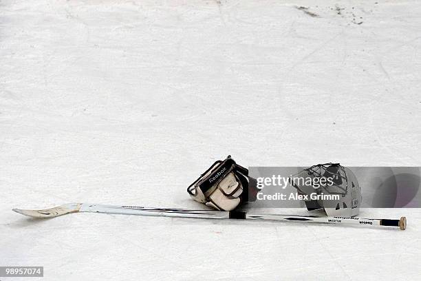 Helmet and stick of goalkeeper Daniel Bellissimo of Italy lie on the ice after the IIHF World Championship group B match between Switzerland and...