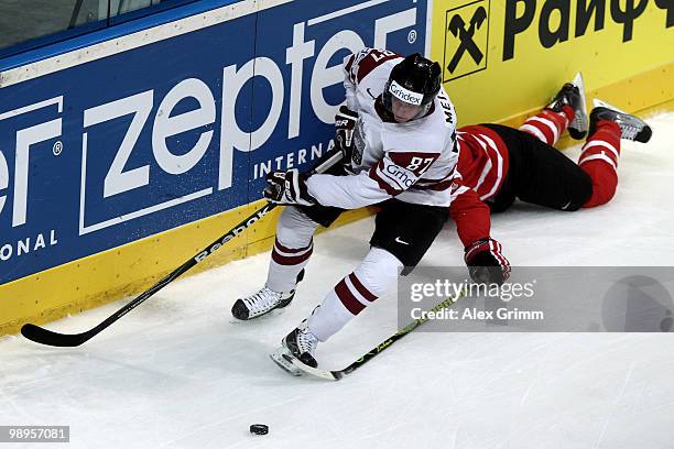 Gints Meija of Latvia is challenged by Brent Burns of Canada during the IIHF World Championship group B match between Switzerland and Italy at SAP...