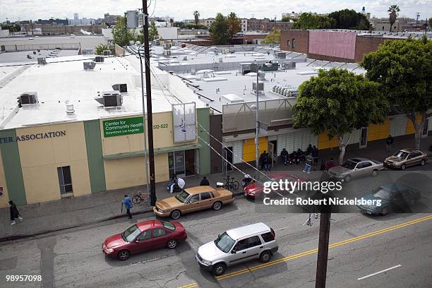 The homeless wait outside city government facilities April 21, 2010 across the street from the converted 75-unit Charles Cobb Apartments in the...