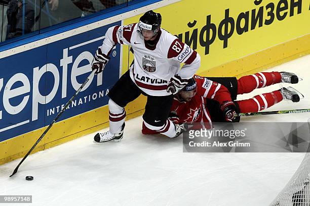 Gints Meija of Latvia is challenged by Brent Burns of Canada during the IIHF World Championship group B match between Switzerland and Italy at SAP...