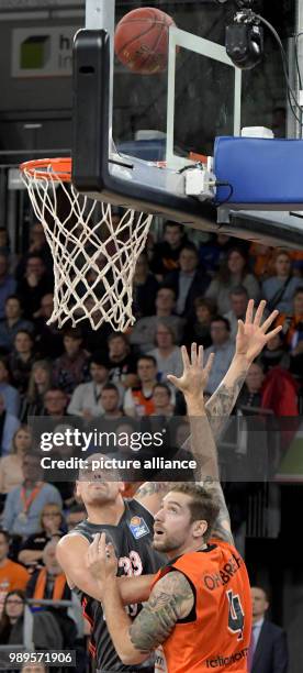 Ulm's Tim Ohlbrecht and Maik Zirbes of Munich vie for the ball during the German Bundesliga basketball game between ratiopharm Ulm and FC Bayern...