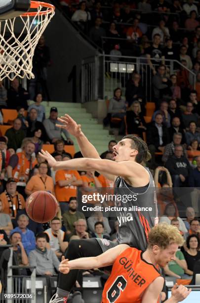 Ulm's Per Guenther and Munich's Nihad Djedovic vie for the ball during the German Bundesliga basketball game between ratiopharm Ulm and FC Bayern...