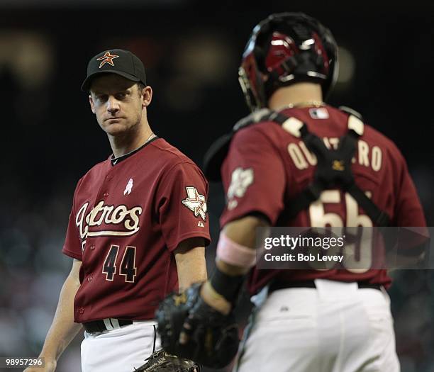 Pitcher Roy Oswalt of the Houston Astros talks with catcher Humberto Quintero during game action against the San Diego Padres at Minute Maid Park on...