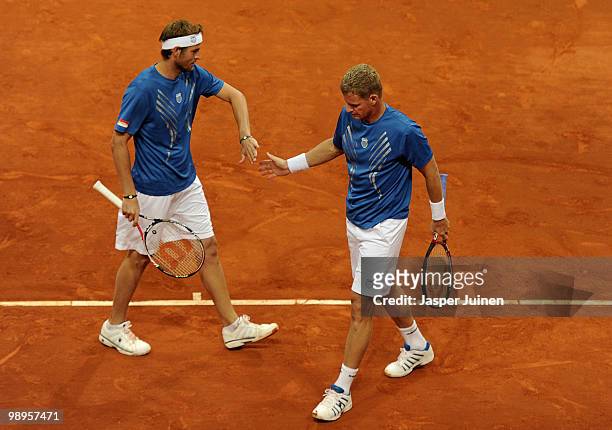 Mardy Fish of the USA celebrates a point with his doubles partner Mark Knowles of the Bahamas in their first round match during the Mutua Madrilena...
