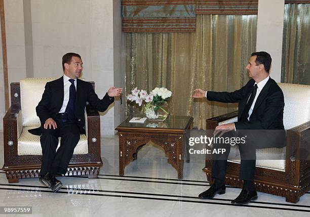 Syrian President Bashar al-Assad speaks with his Russian counterpart Dmitry Medvedev at Al-Shaab presidential palace in Damascus on May 10, 2010....