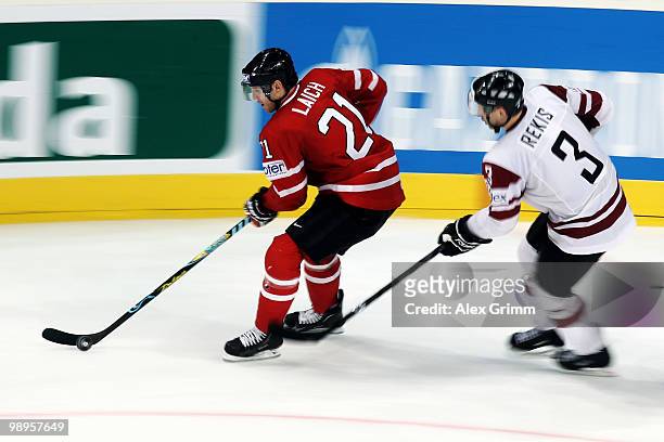 Brooks Laich of Canada is challenged by Arvids Rekis of Latvia during the IIHF World Championship group B match between Switzerland and Italy at SAP...
