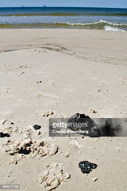Five-inch-wide oil tar ball sits on the west end shore of Dauphin Island, Alabama, U.S., on Sunday, May 9, 2010. Oil has been gushing from the...
