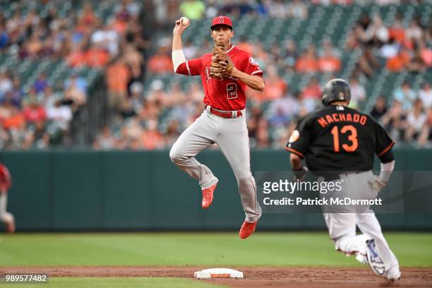 Andrelton Simmons of the Los Angeles Angels of Anaheim jumps over Manny Machado of the Baltimore Orioles as he turns a double play in the first...