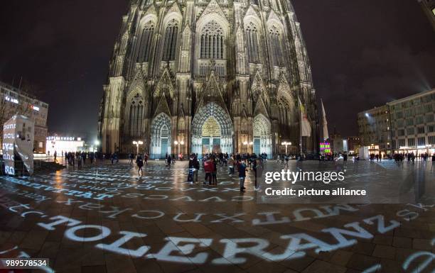 "Toleranz" and other words are projected onto the Domplatte as part of a light installation by artist Ingo Dietzel in Cologne, Germany, 30 December...