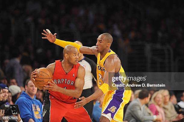 Jarrett Jack of the Toronto Raptors moves the ball against Kobe Bryant of the Los Angeles Lakers at Staples Center on March 9, 2010 in Los Angeles,...