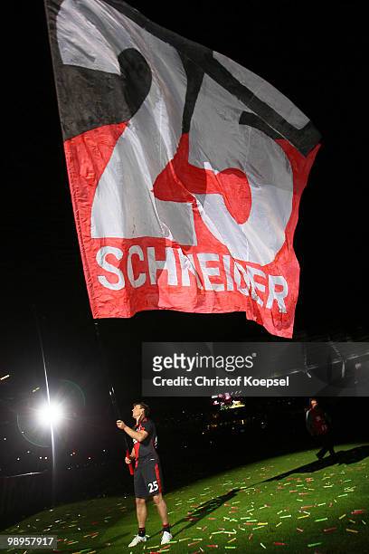 Bernd Schneider of Leverkusen waves a flag after the Bernd Schneider farewell match between Bayer Leverkusen and Schnix All Stars at the BayArena on...