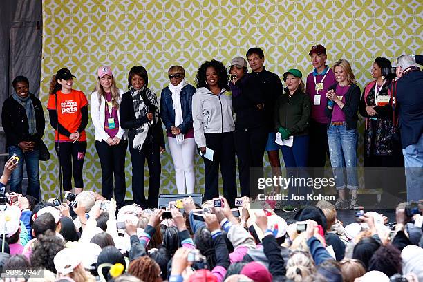 Oprah Winfrey stands on stage with Elizabeth Banks, Tracy Chapman, Mary J. Blige, Jennifer Hudson, Bette Midler and Dr. Mehmet Oz at the finish line...