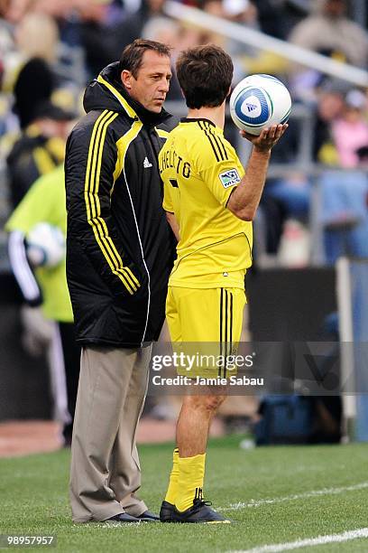 Head coach Robert Warzycha of the Columbus Crew talks with Guillermo Barros Schelotto of the Columbus Crew on May 8, 2010 at Crew Stadium in...