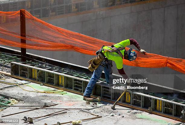 Man works at the south memorial pit at the World Trade Center construction site in New York, U.S., on Monday, May 10, 2010. One World Trade Center,...