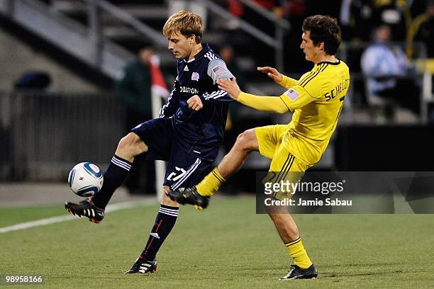 Seth Sinovic of the New England Revolution controls the ball in front of Guillermo Barros Schelotto of the Columbus Crew on May 8, 2010 at Crew...