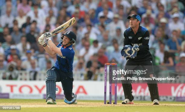 England captain Eoin Morgan hits a six during his innings of 88 runs watched by New Zealand wicketkeeper Luke Ronchi in the 2nd Royal London One Day...