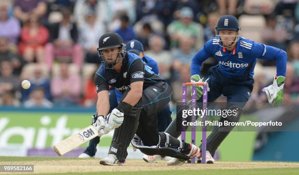 Ross Taylor of New Zealand prepares to sweep the ball during his innings of 110 as England wicketkeeper Jos Buttler anticipates the shot during the...