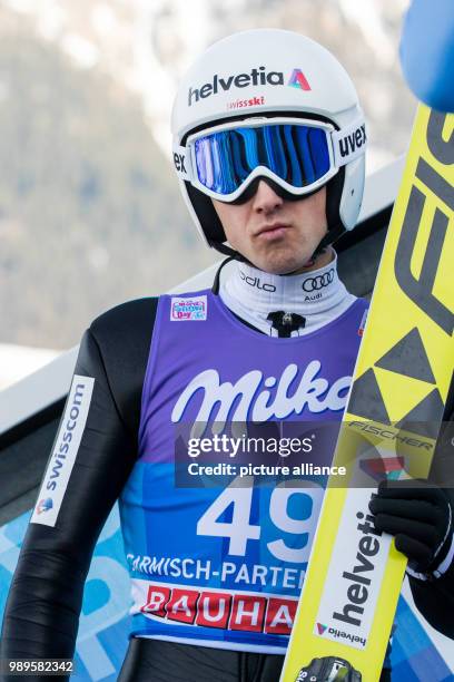 Simon Amman of Switzerland sitting during the trial round of the men's large hill ski jumping event at the Four Hills Tournament in...