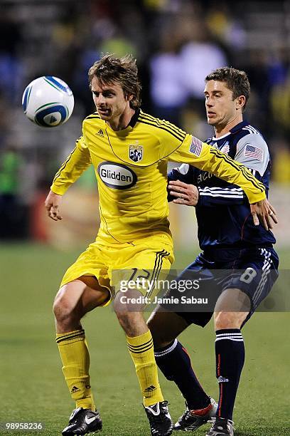 Eddie Gaven of the Columbus Crew fends off Chris Tierney of the New England Revolution as he controls the ball on May 8, 2010 at Crew Stadium in...