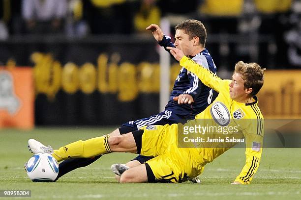 Brian Carroll of the Columbus Crew and Chris Tierney of the New England Revolution battle for control of a loose ball on May 8, 2010 at Crew Stadium...