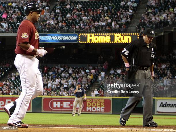 Carlos Lee of the Houston Astros runs to home plate after hitting a home run in the sixth inning against the San Diego Padres while umpire Alfonso...