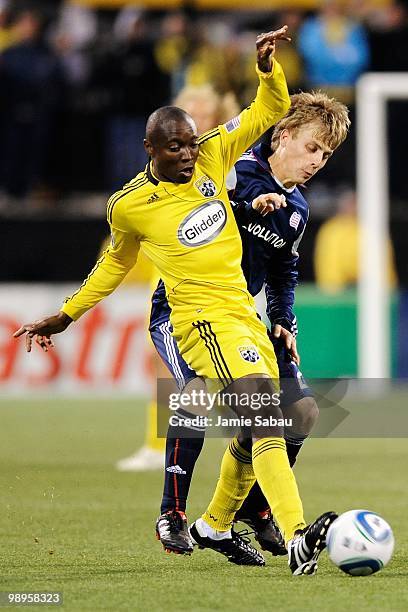 Emmanuel Ekpo of the Columbus Crew battles Seth Sinovic of the New England Revolution for control of the ball on May 8, 2010 at Crew Stadium in...