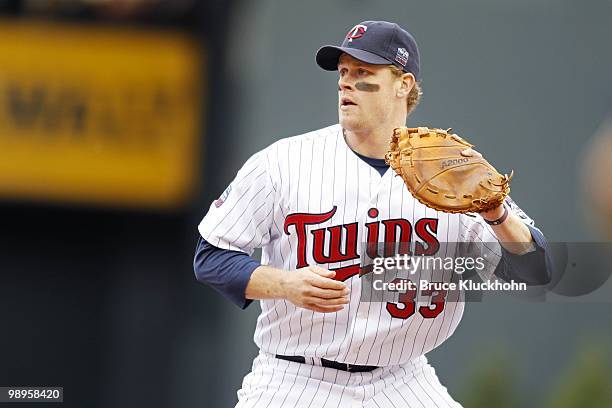 Justin Morneau of the Minnesota Twins fields a ball by the Detroit Tigers on May 5, 2010 at Target Field in Minneapolis, Minnesota. The Twins won 5-4.