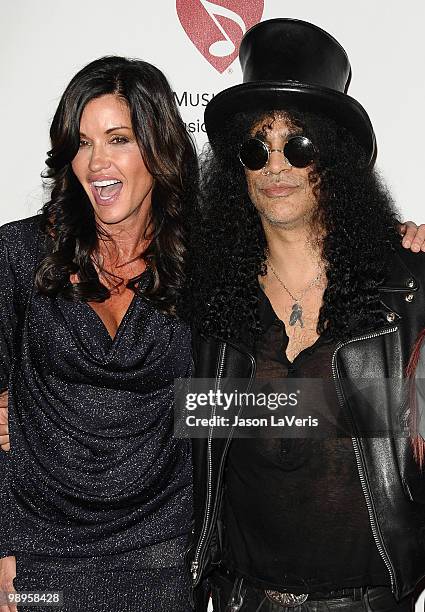 Janice Dickinson and Slash attend the 6th annual MusiCares MAP Fund benefit concert at Club Nokia on May 7, 2010 in Los Angeles, California.