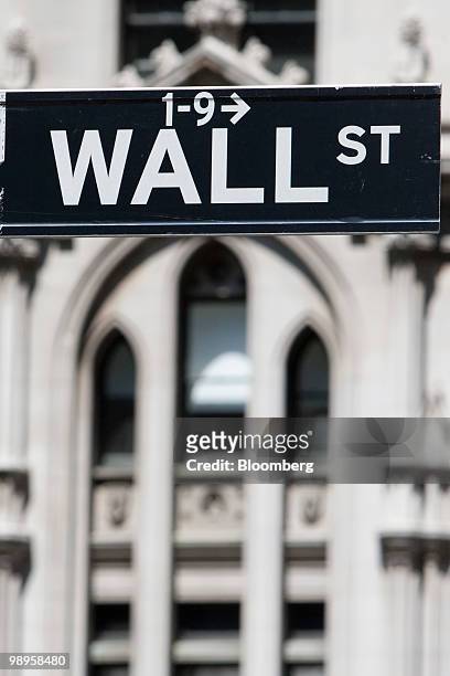 Wall Street sign hangs in New York, U.S., on Monday, May 10, 2010. Stocks rallied around the world, sending the MSCI World Index up the most in 13...