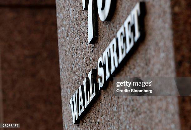 Wall Street sign hangs in New York, U.S., on Monday, May 10, 2010. Stocks rallied around the world, sending the MSCI World Index up the most in 13...