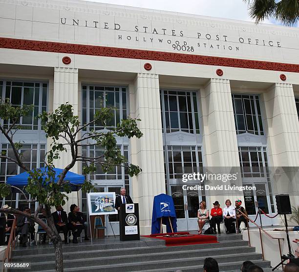 Los Angeles city council member Tom LaBonge speaks at the podium during the Johnny Grant post office dedication at the Hollywood post office on May...