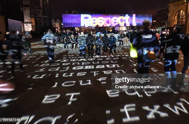 Visitors contemplate the light show created by artist Ingo Dietzel in Cologne, Germany, 31 December 2017. Great measures of security were taken...