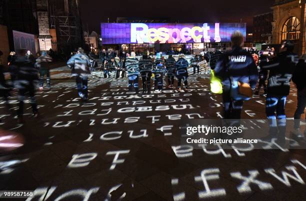 Visitors contemplate the light show created by artist Ingo Dietzel in Cologne, Germany, 31 December 2017. Great measures of security were taken...