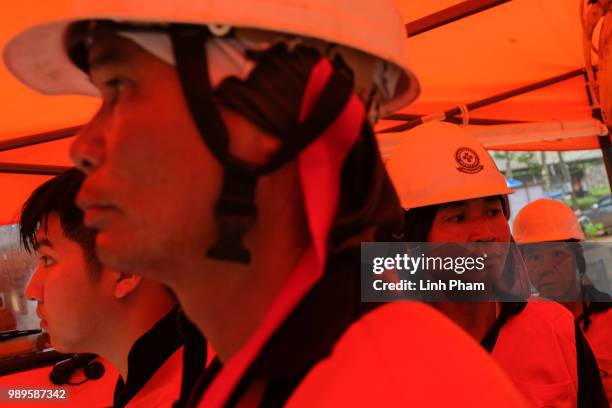 Rescue workers wait at the entrance of Tham Luang Nang Non cave on July 2, 2018 in Chiang Rai, Thailand. Rescuers from China and Australia have...