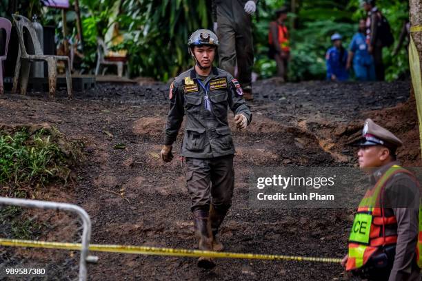 Rescuer walks out of Tham Luang Nang Non cave on July 2, 2018 in Chiang Rai, Thailand. Rescuers from China and Australia have recently joined the...