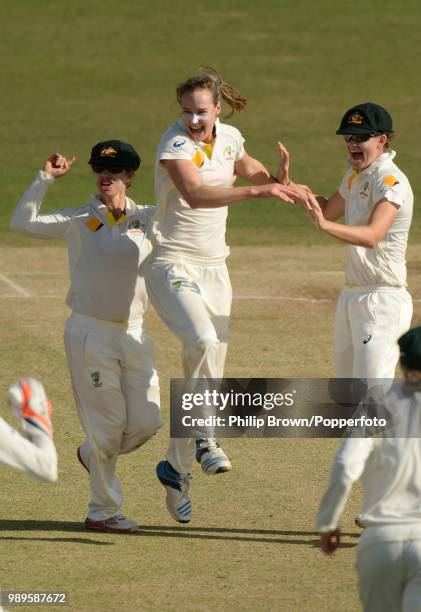 Ellyse Perry of Australia celebrates with teammates Nicole Bolton and Jess Jonassen after dismissing Laura Marsh of England during the Women's Ashes...