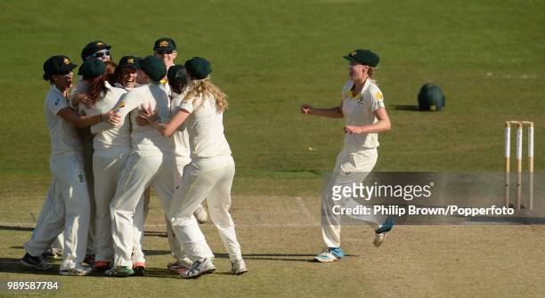 Ellyse Perry of Australia runs to join her teammates as Australia celebrate beating England by 161 runs in the Women's Ashes Test match at the St...