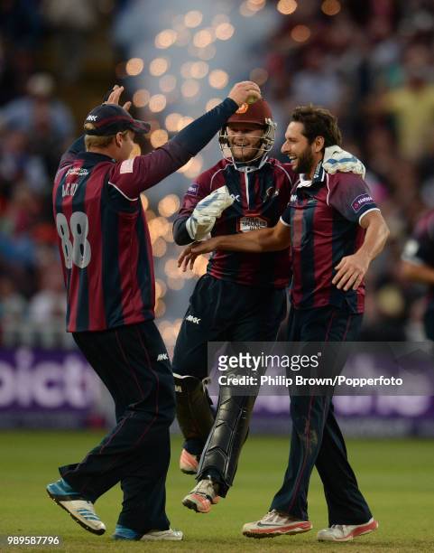 Shahid Afridi of Northamptonshire celebrates with teammates Richard Levi and Ben Duckett after dismissing James Faulkner of Lancashire during the...